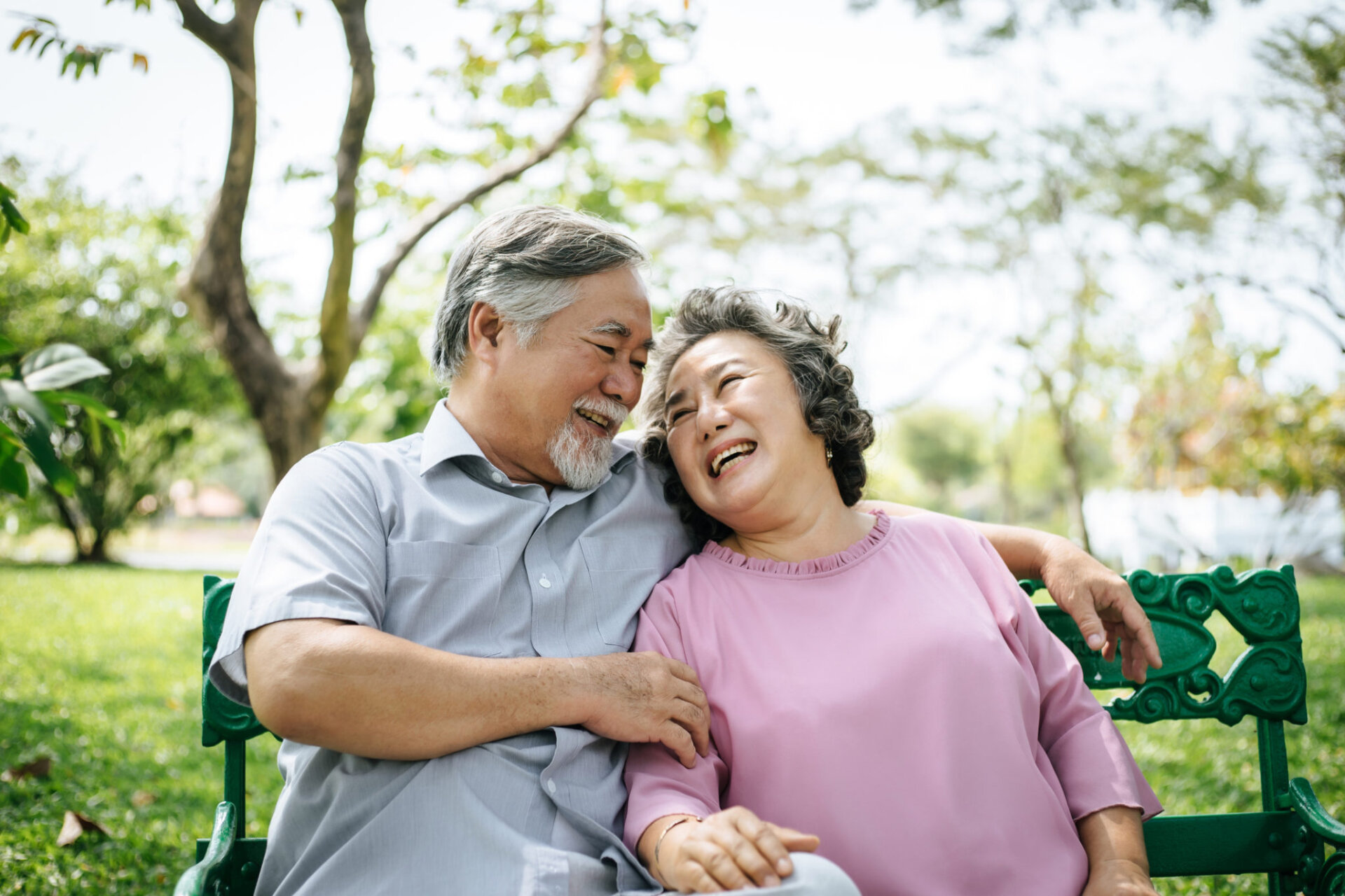 Senior couple relaxing on the bench in the park