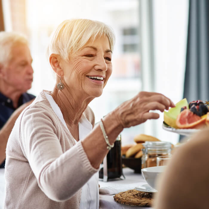 grabbing fruit off a tray