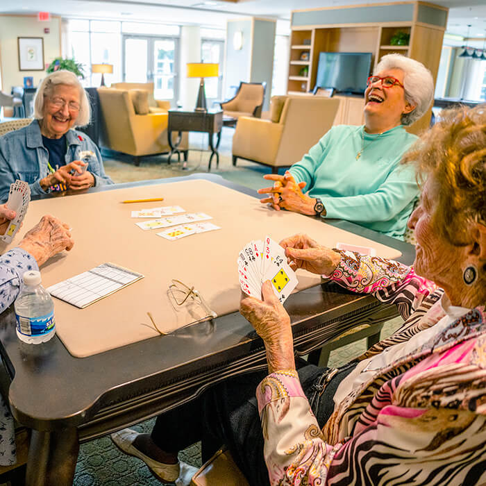 Senior playing cards together