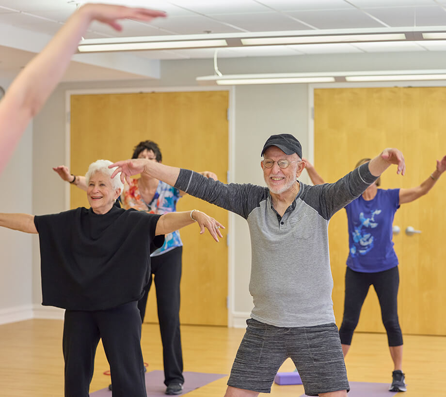 Senior adults participating in a group exercise class at a senior living community.